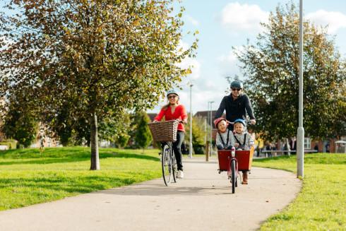 two adults and two children playing on bicycles