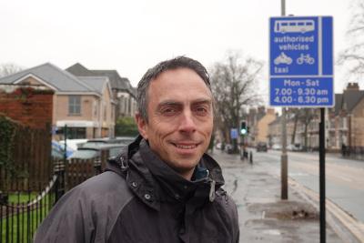 Councillor Mike Ross, leader of Hull City Council, with one of the new signs promoting the changes to bus lane operating times