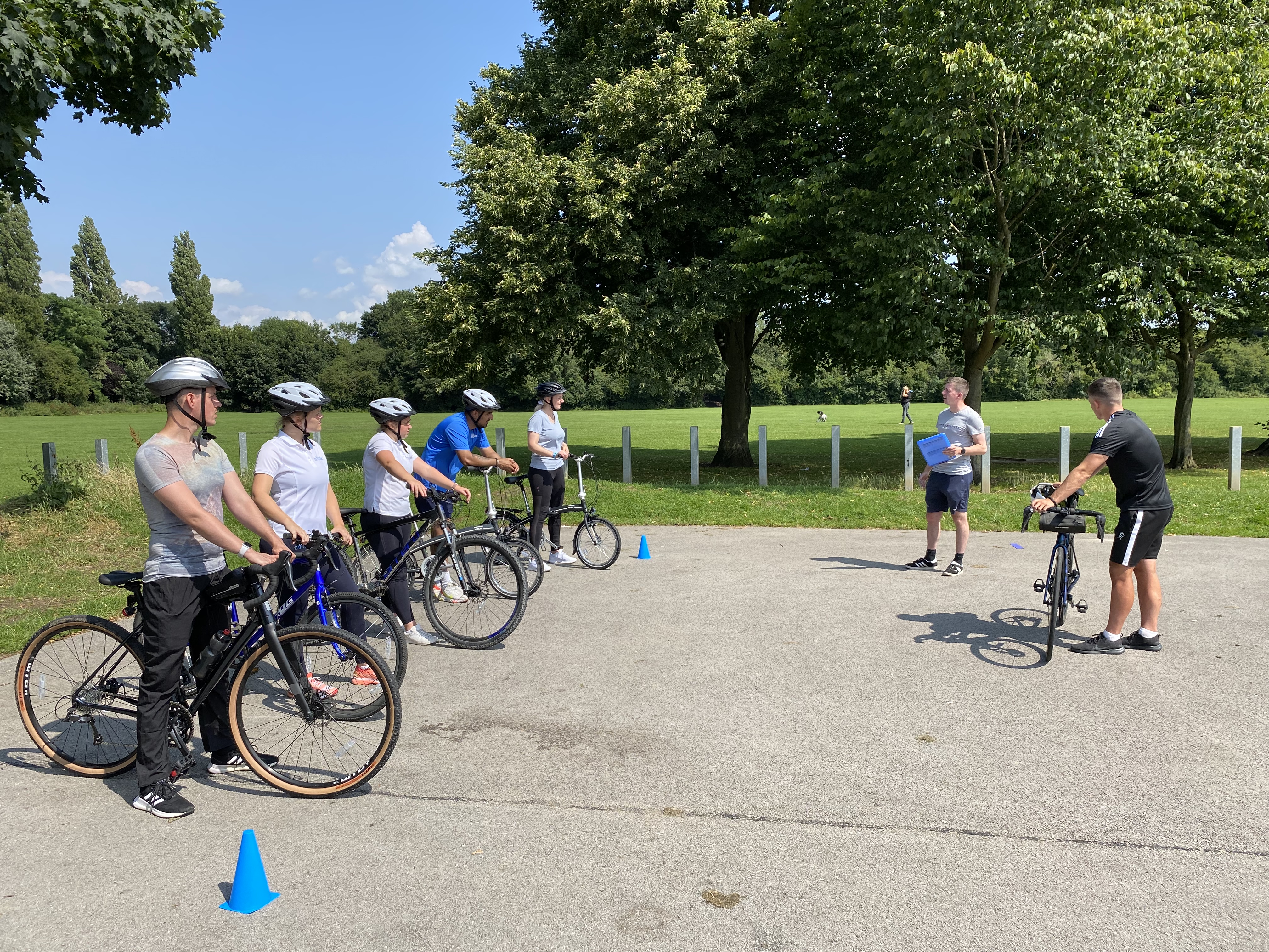 A group of adults taking part in a cycle training session.