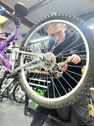 person fixing a bicycle