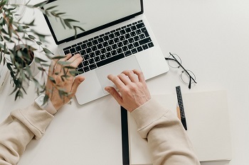 Hand with a laptop completing a consultation