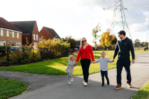 two adults and two children walking