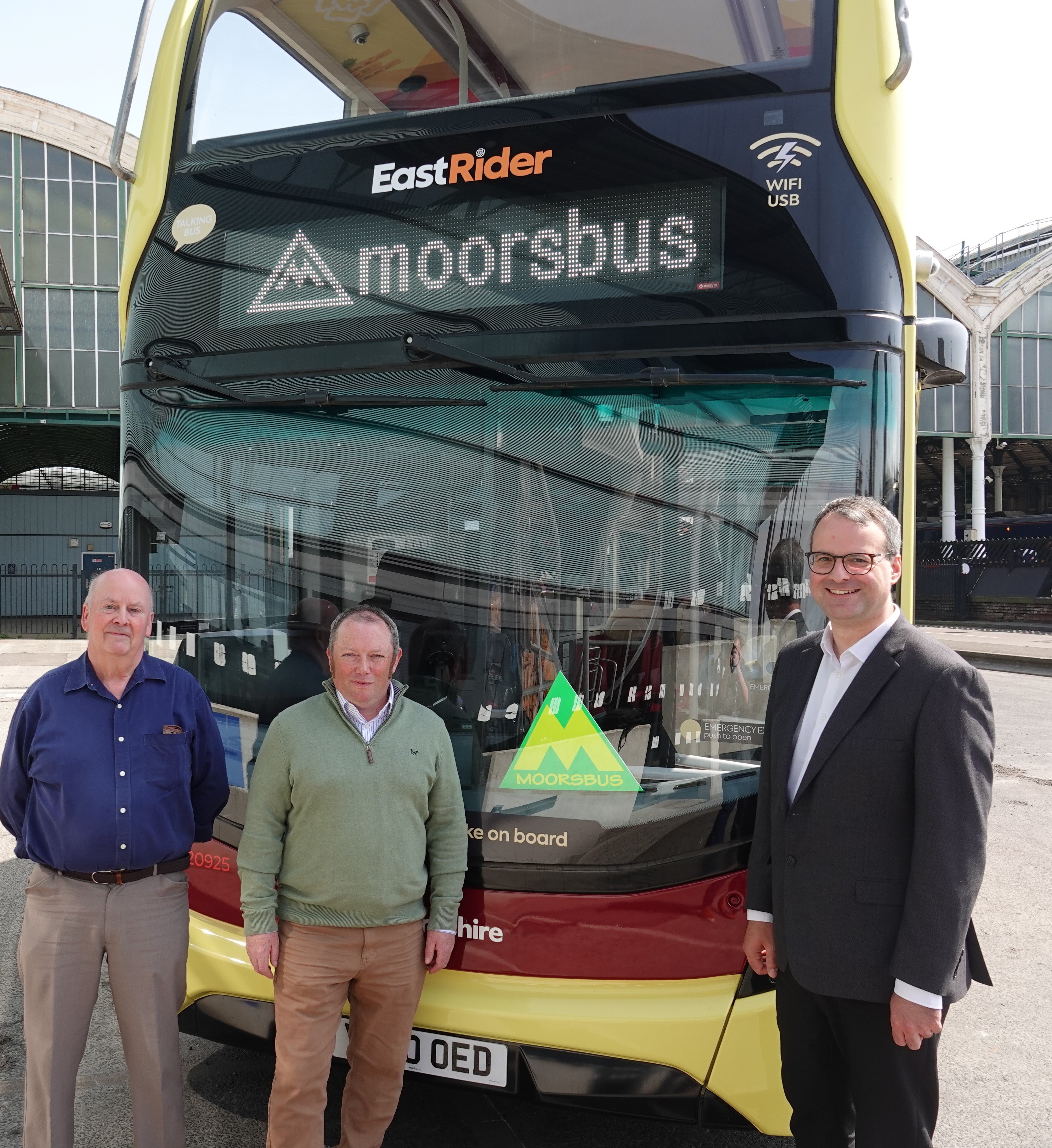 Eden Blyth, Councillor Paul West and Councillor Mark Ieronimo with the Moorsbus M1 Service at Hull Paragon Interchange