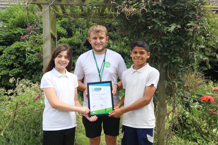 two children being awarded a certificate