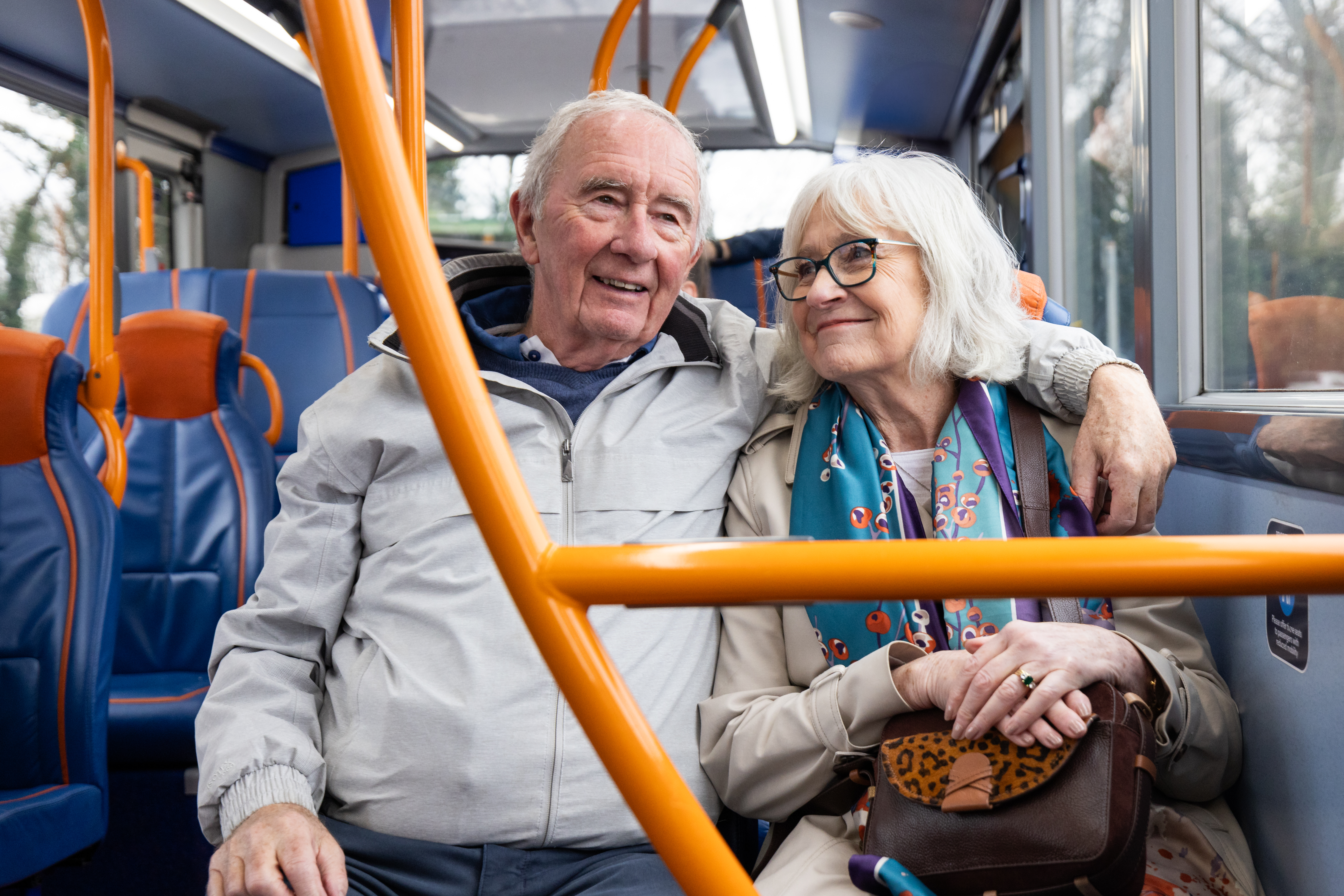 An older couple riding the bus